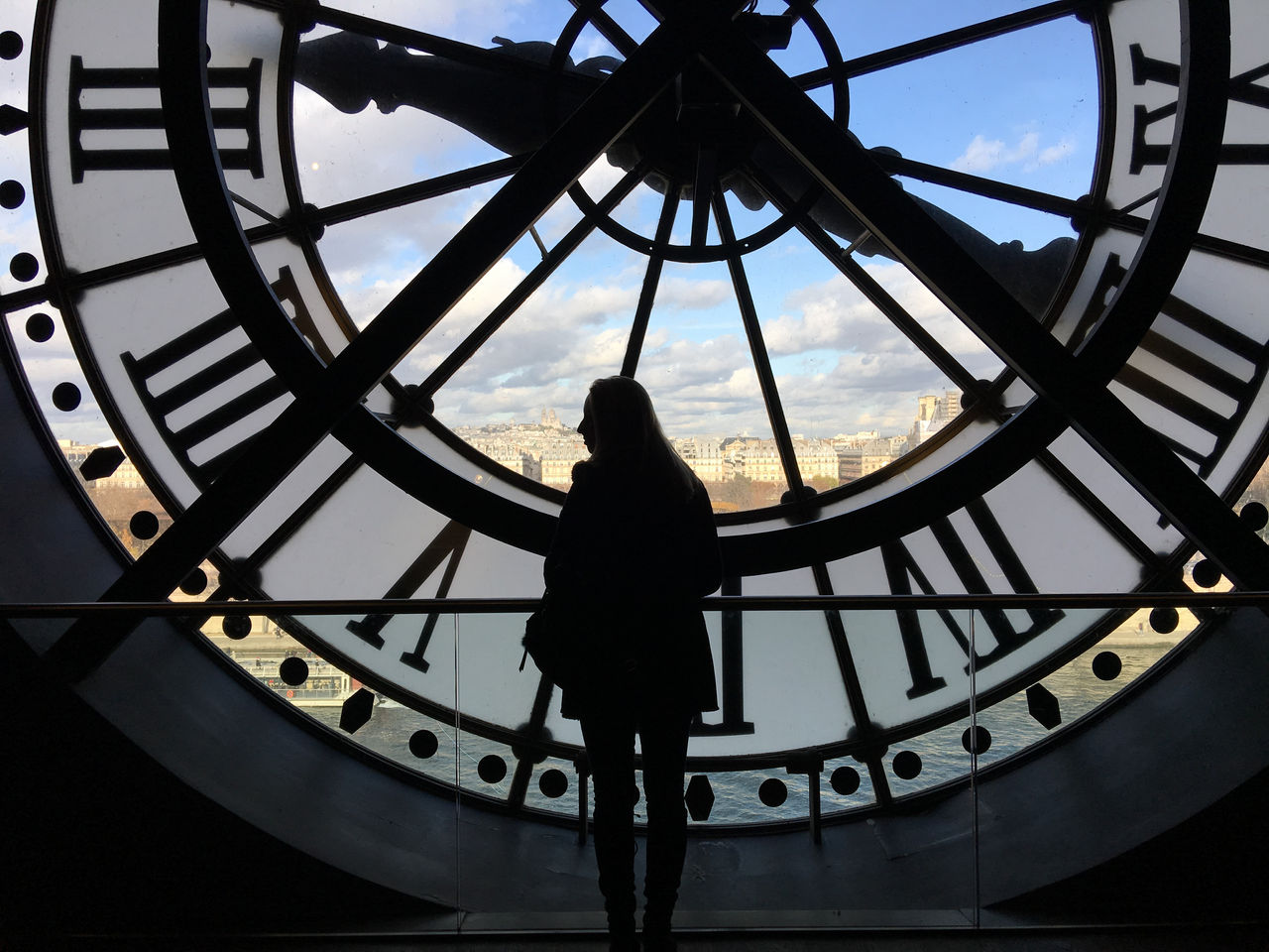 Low Angle View Of Silhouette Woman Standing Against Clock Tower